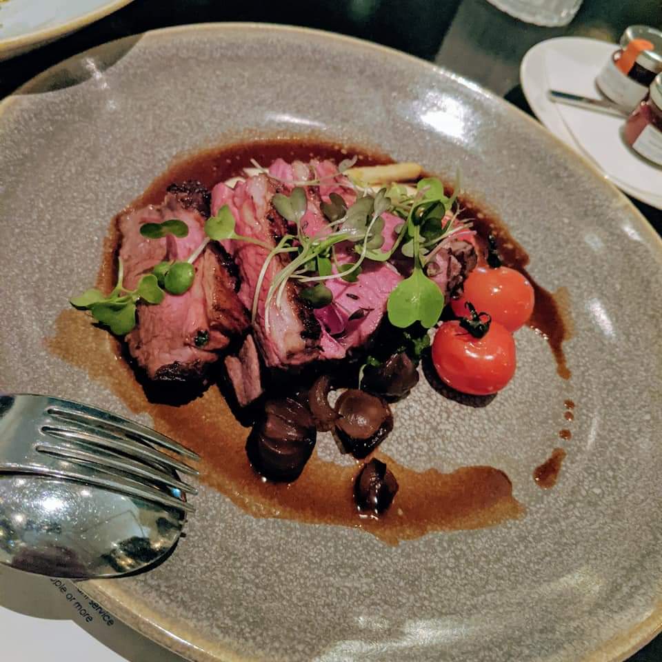 Plated steak dish at Glass Brasserie